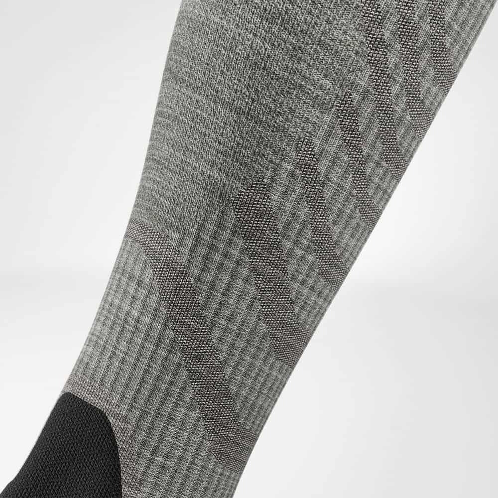 Gray sock with black heel and toe on a light gray background