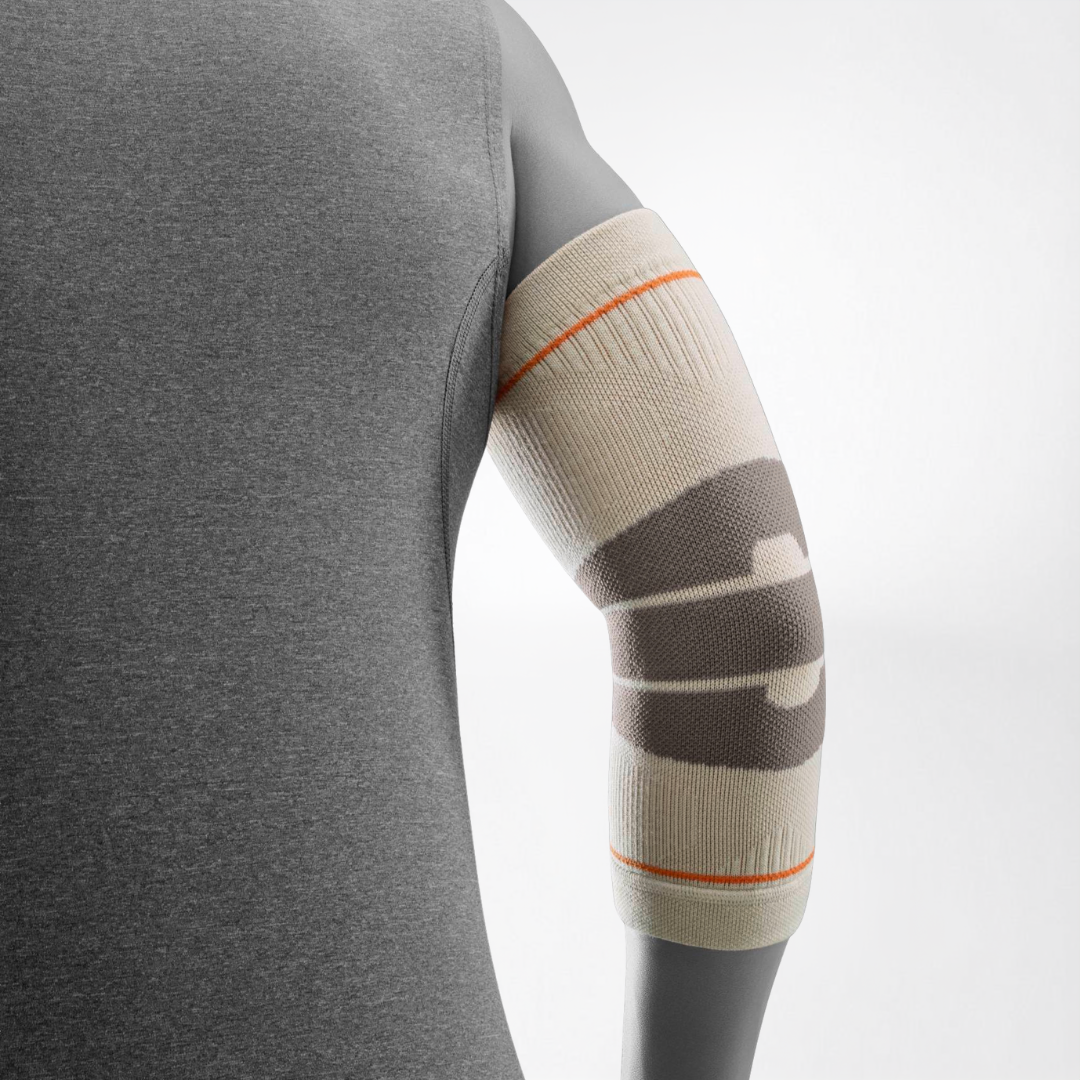 A close-up of a person's arm wearing a Bauerfeind Sports outdoor elbow compression sleeve with a light gray background.