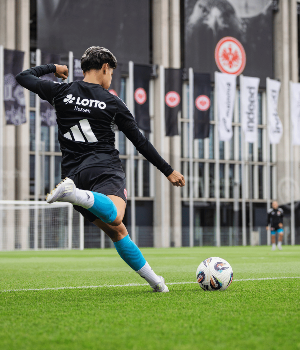 man wearing bauerfeind sports compression calf sleeves kicking a soccer ball