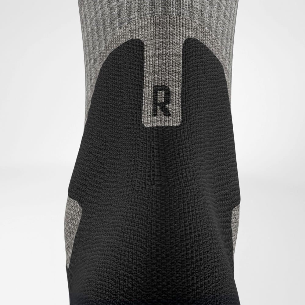 Black and gray sock with a logo on a white background