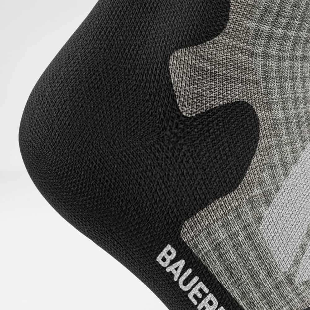 Close-up of black and gray hockey socks with 'BAUERFEIND' branding on a white background