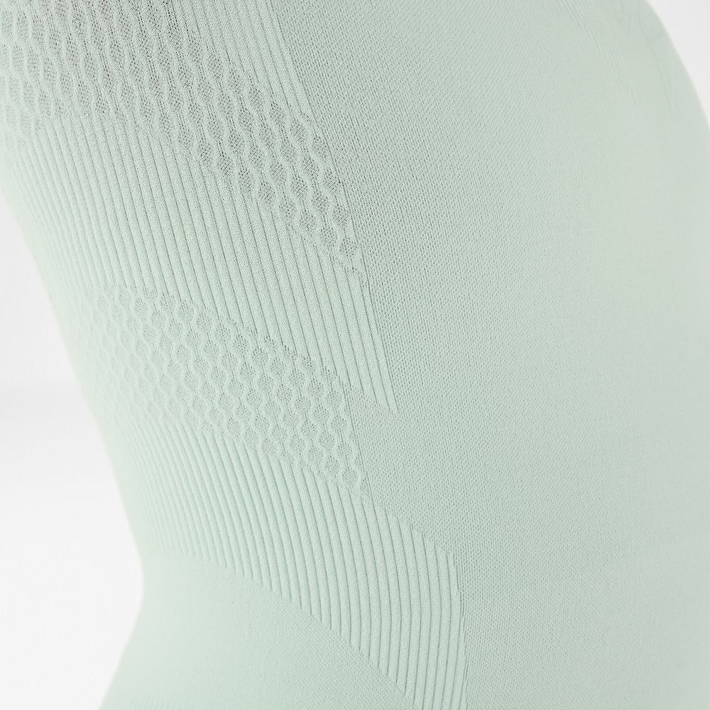 mint green sleeveless bauerfeind compression top with textured pattern on a white background