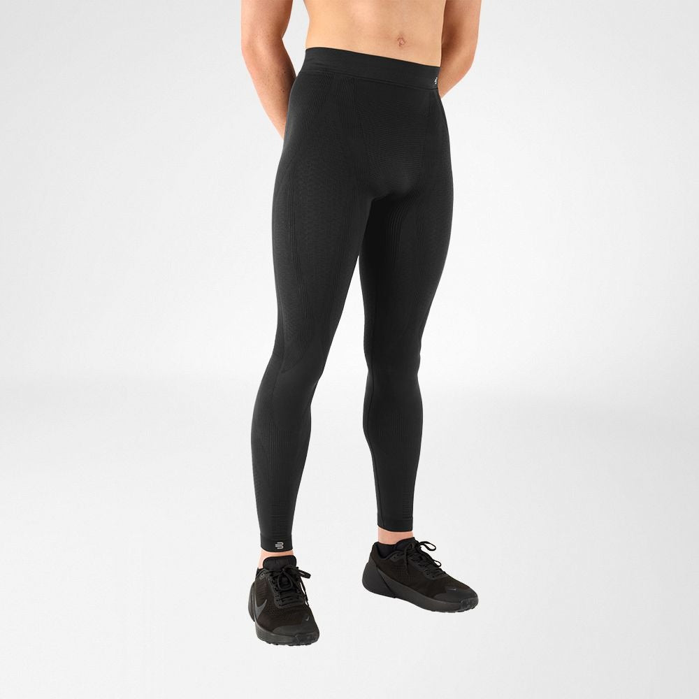 Person wearing bauerfeind sport mens compression leggings on a white background
