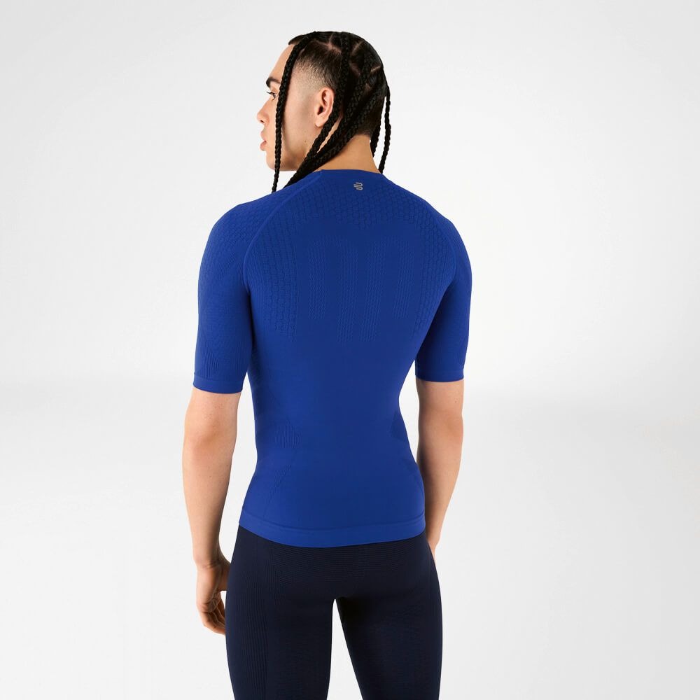 Person wearing blue athletic Bauerfeind men's Sports Compression Short Sleeve Shirt and Navy blue Bauerfeind's Men Sport compression shorts on a white background