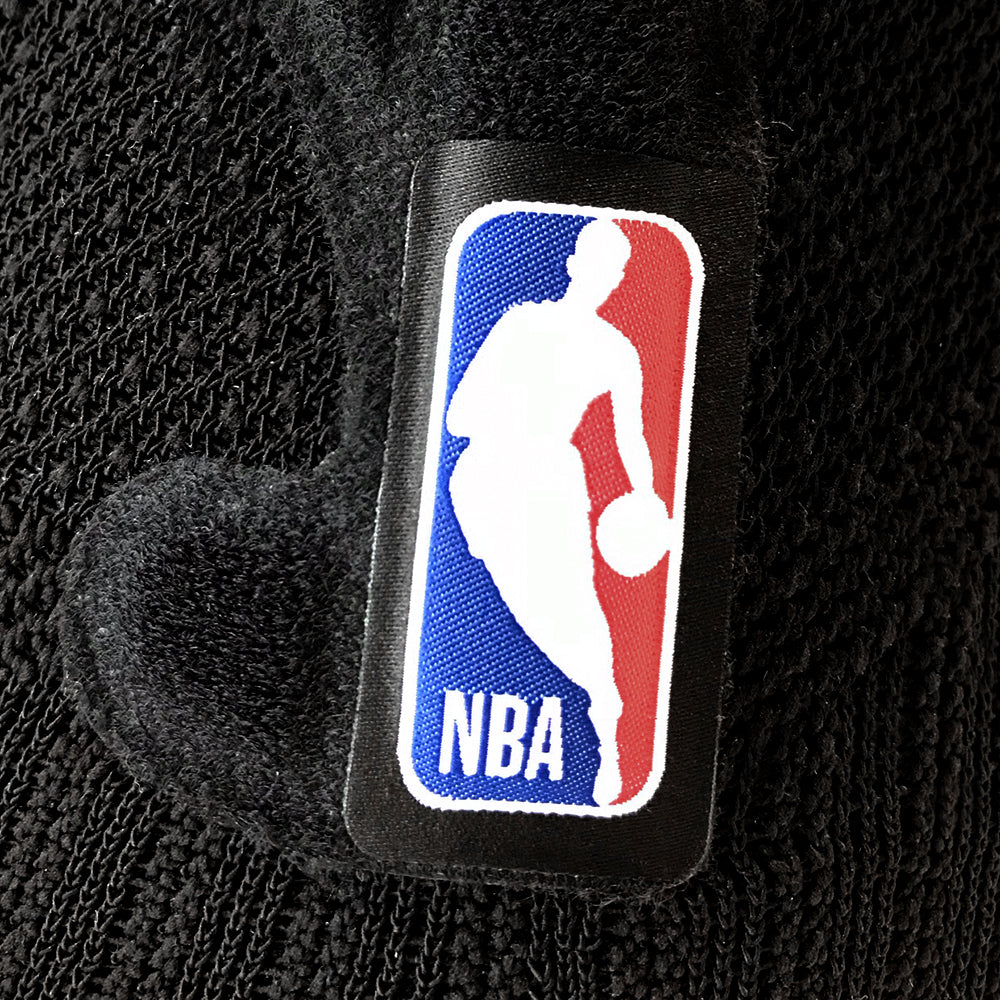 Closeup of the logo on a black Bauerfeind Sports Knee Support NBA