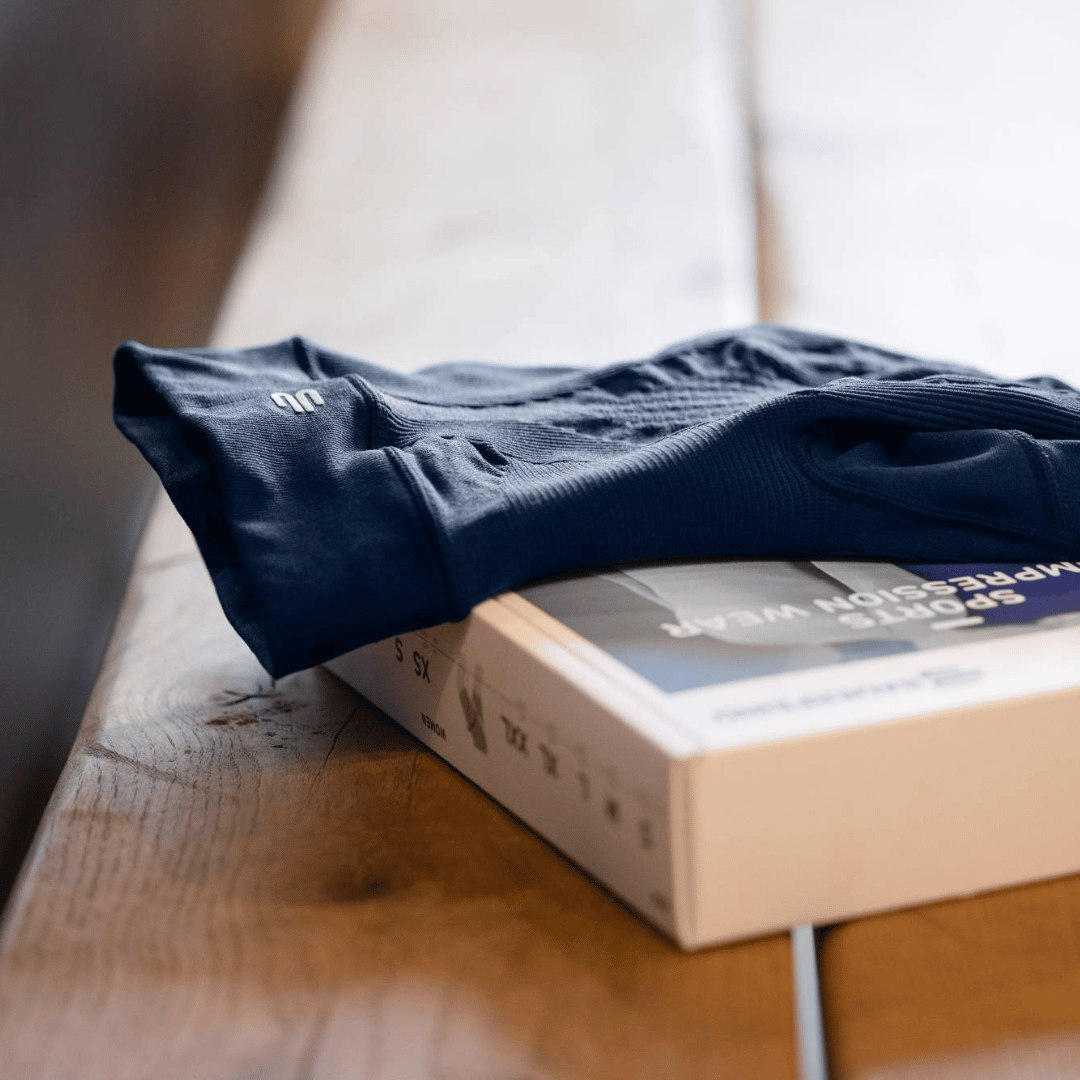 Bauerfeind's Sport Compression Legging and product box with a blurred background