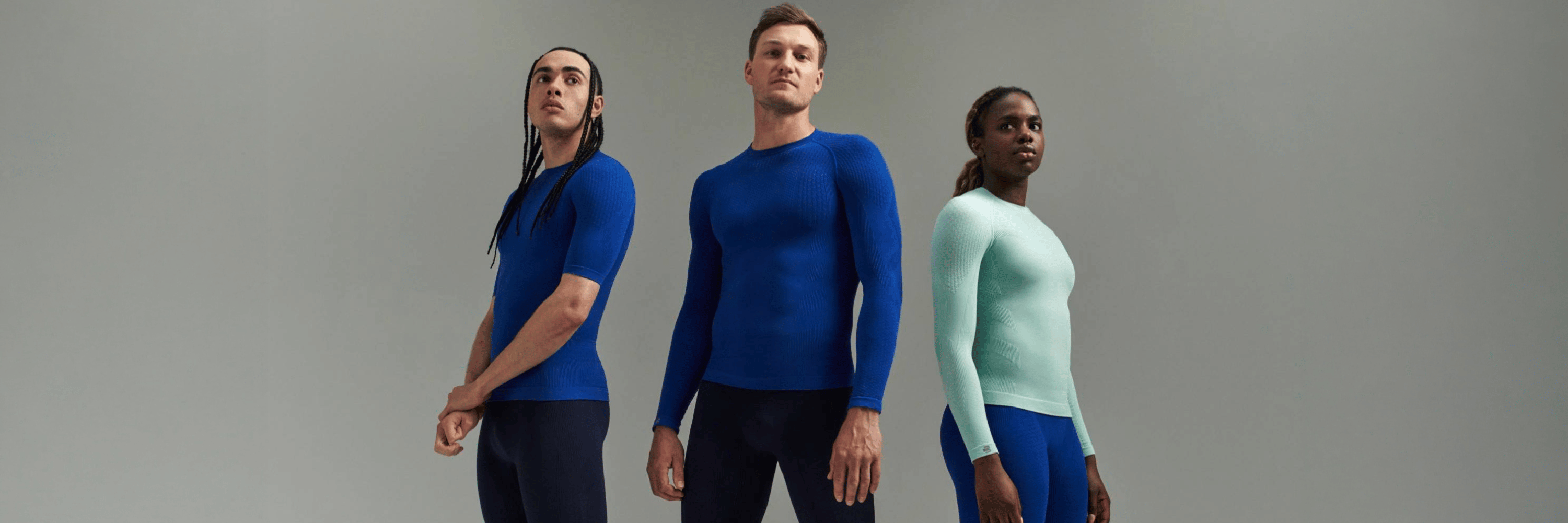 Three people wearing Bauerfeind sport compression wear collection against a gray background