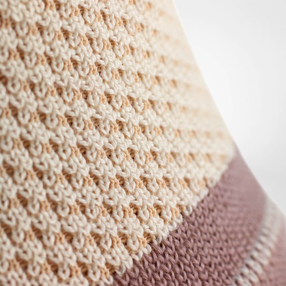 Close-up of a knitted fabric with a patterned texture.