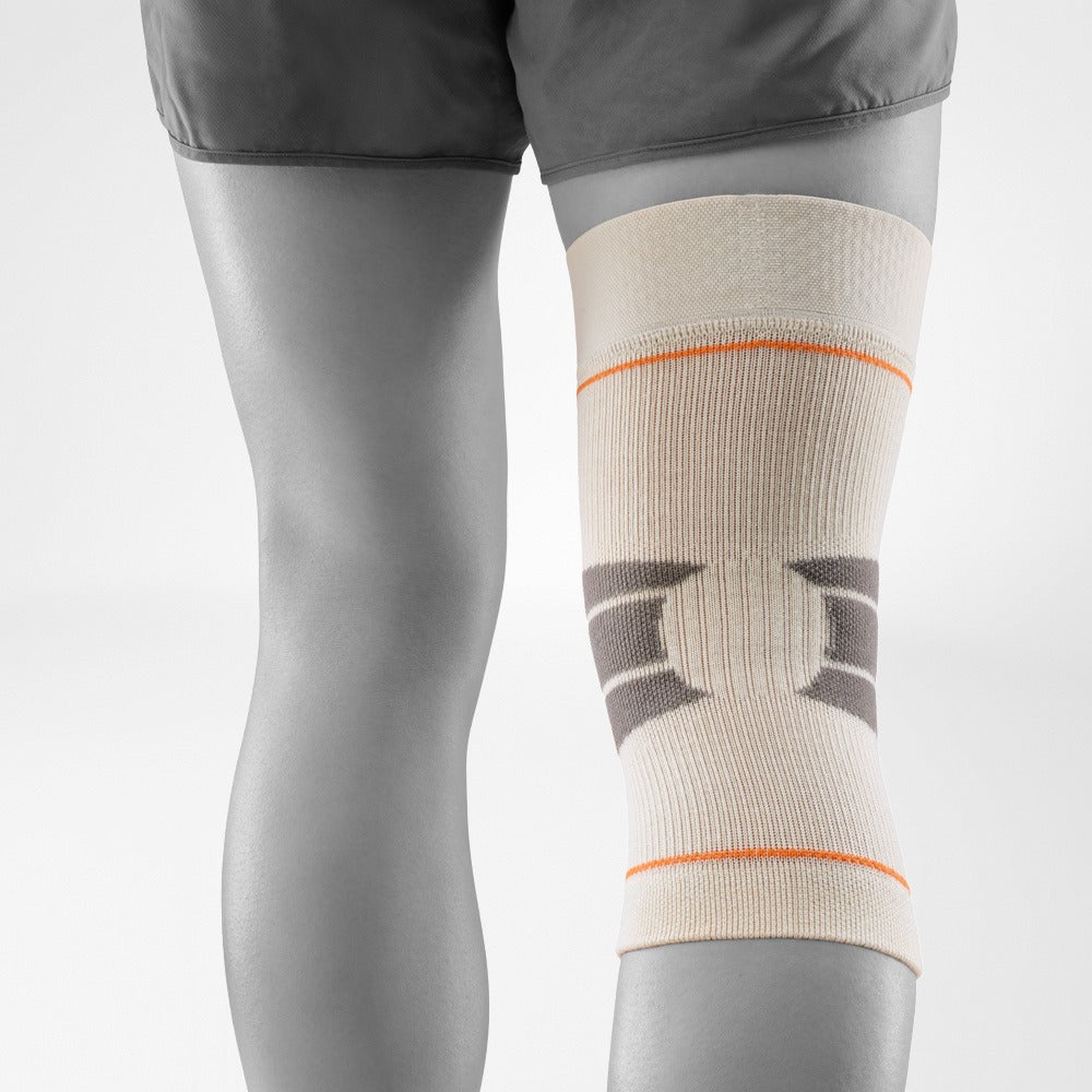 Person wearing a knee brace on a light gray background