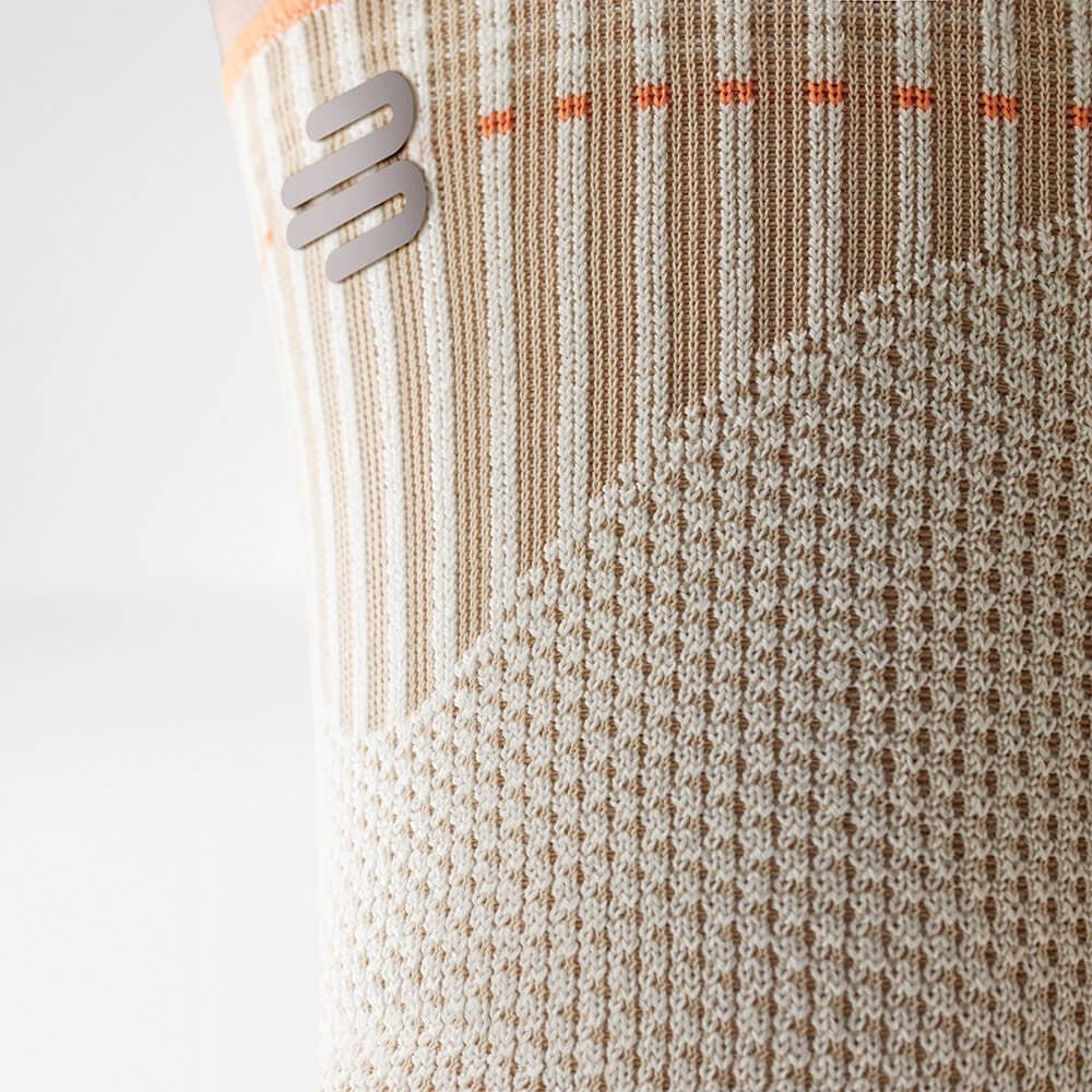 Close-up of a textured fabric with a bauerfeind logo on a white background
