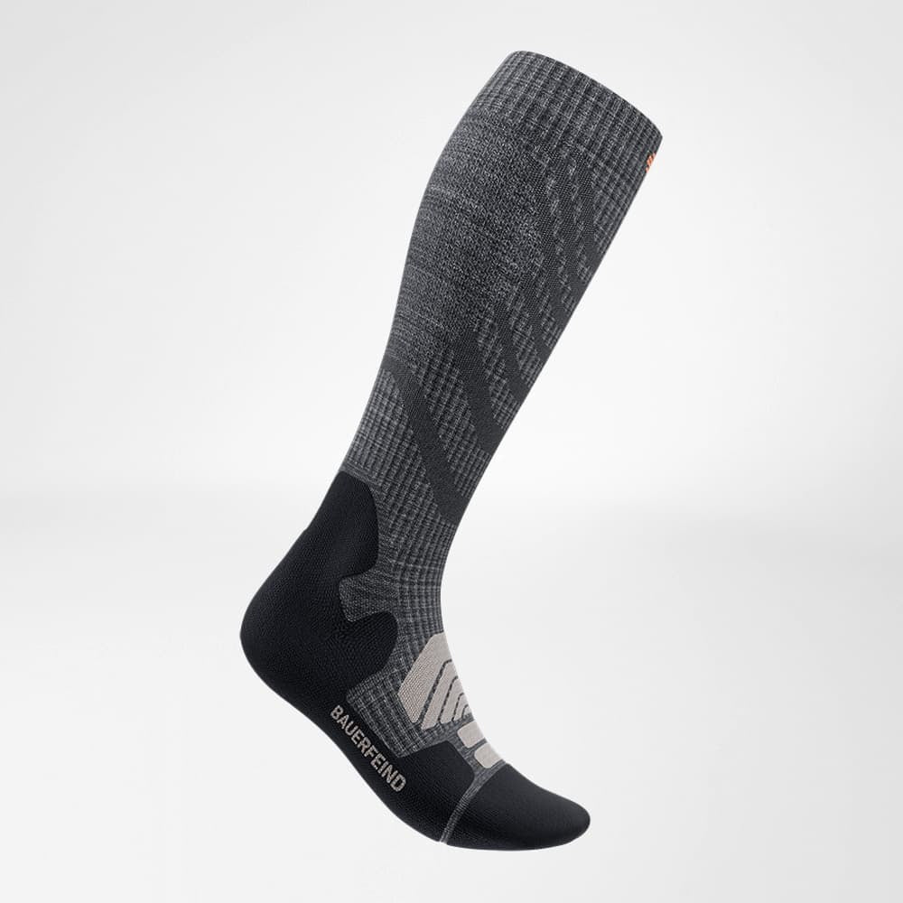 Gray and black knee-high sock with brand logo on a light gray background