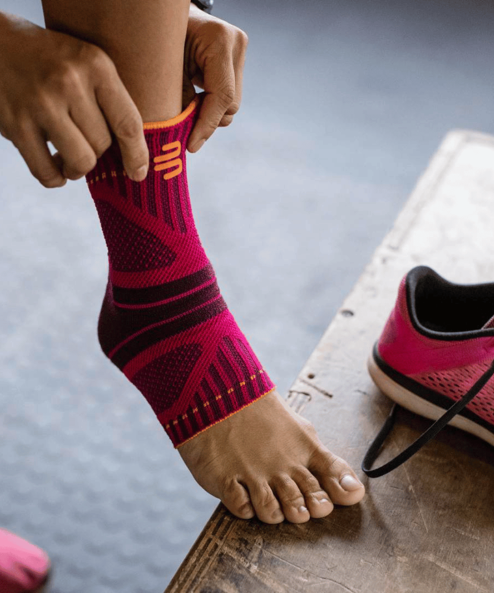 Woman putting on pink ankle support 