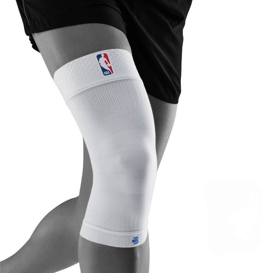 A person wearing a white bauerfeind Sports Compression Knee Support NBA