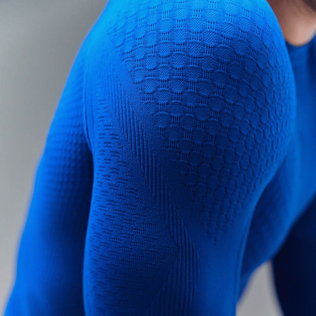 Close-up of a blue Baerfeind sport compression long-sleeve shirt on a neutral background