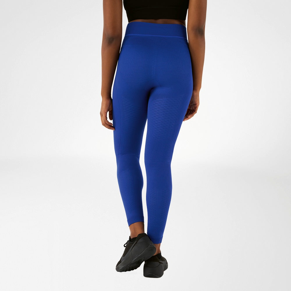 Person wearing blue athletic Bauerfeind Women's sport compression Leggings and black sports bra on a white background