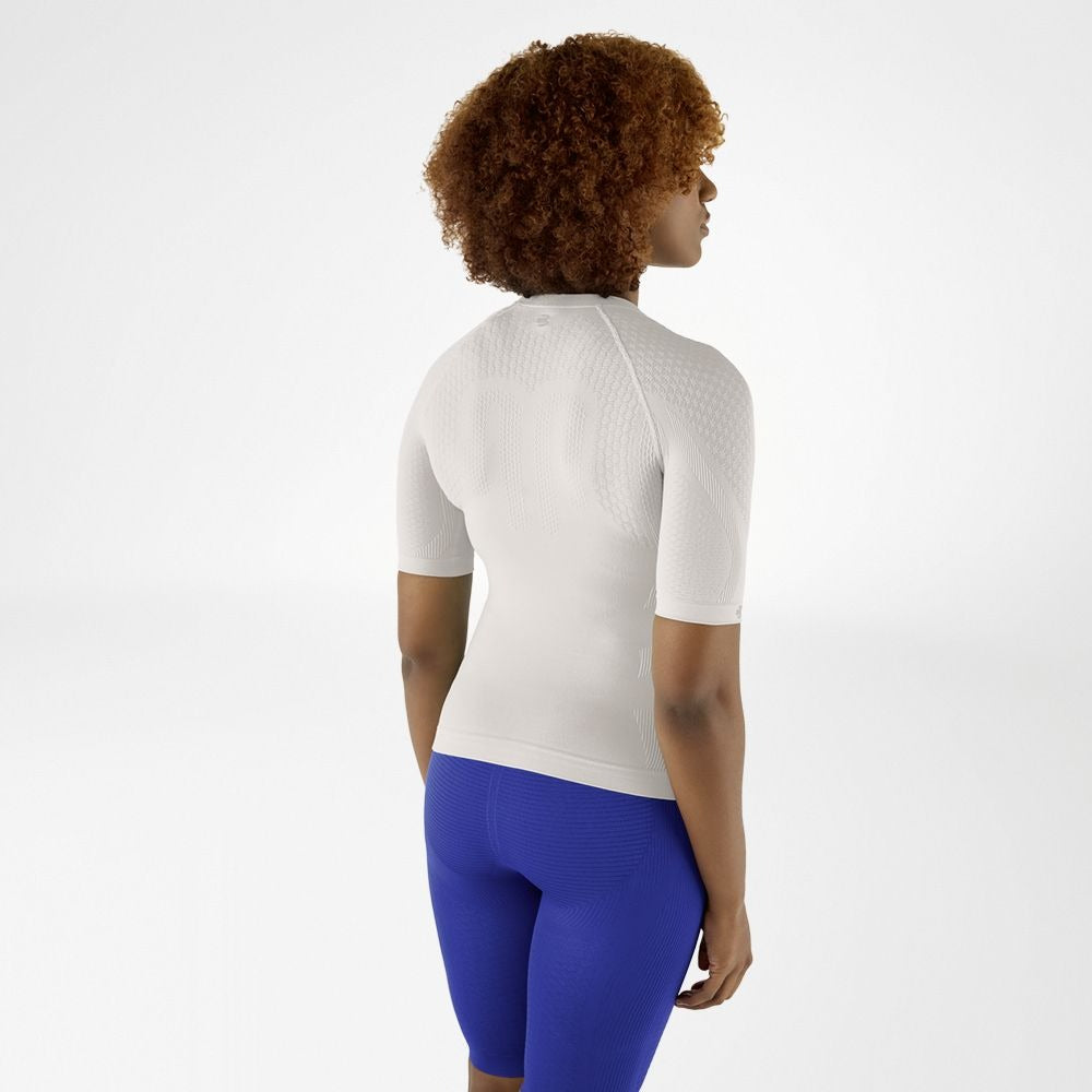 Person wearing light grey silver athletic Bauerfeind Women's Sports Compression Short Sleeve Shirt and blue Bauerfeind Women's sport compression shorts on a white background