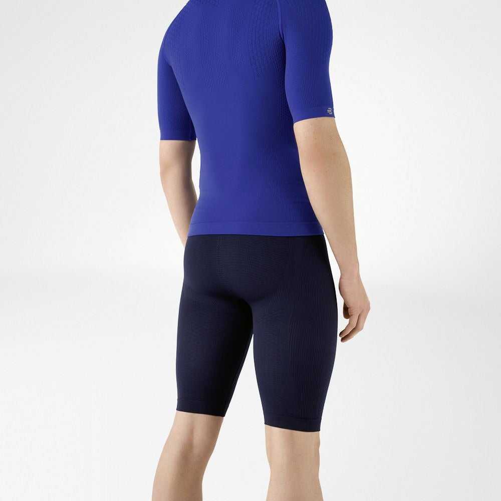 Person wearing blue athletic Bauerfeind men's Sports Compression Short Sleeve Shirt and Navy blue Bauerfeind's Men Sport compression shorts on a white background
