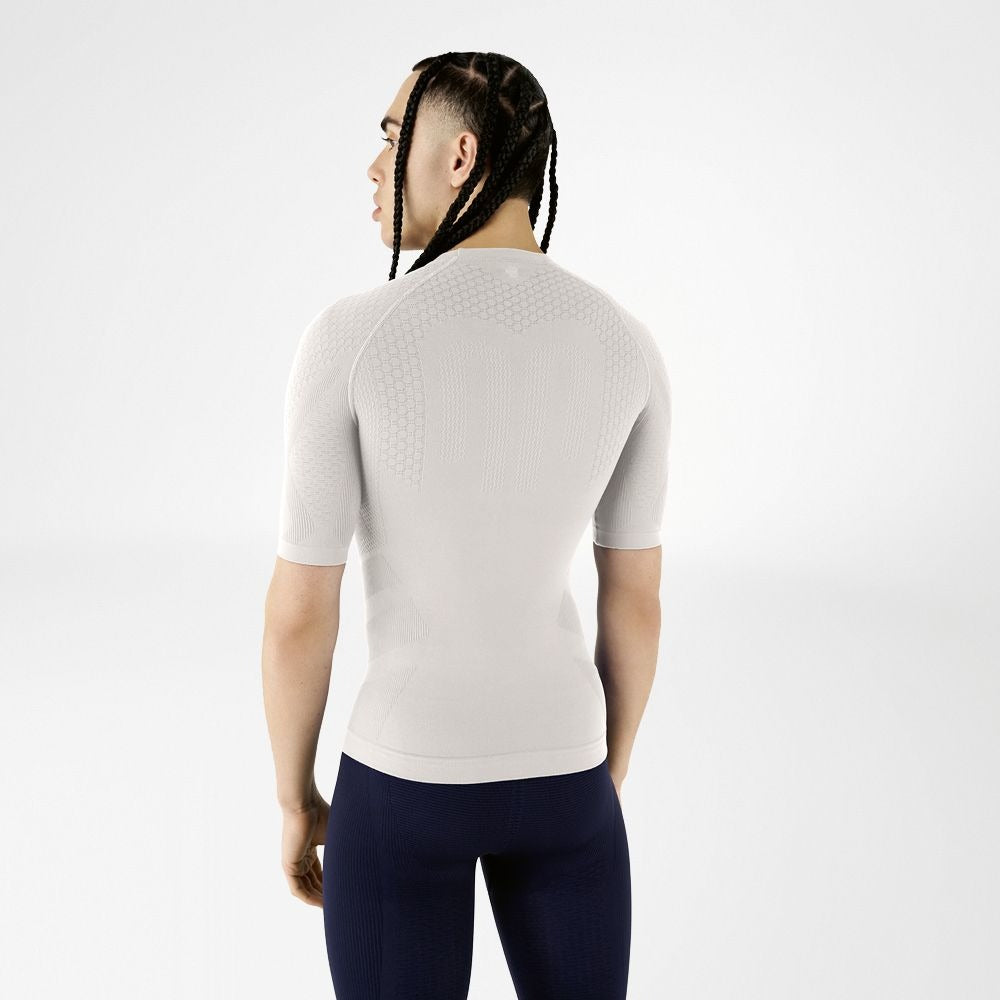 Person wearing silver athletic Bauerfeind men's Sports Compression Short Sleeve Shirt and Navy blue Bauerfeind's Men Sport compression shorts on a white background