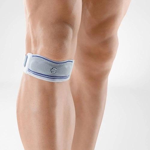 Knee strap in a colour combination of blue and grey and is worn on the right knee. It is considered one of Bauerfeind Australia's best recovery knee straps, GenuPoint Knee Strap.