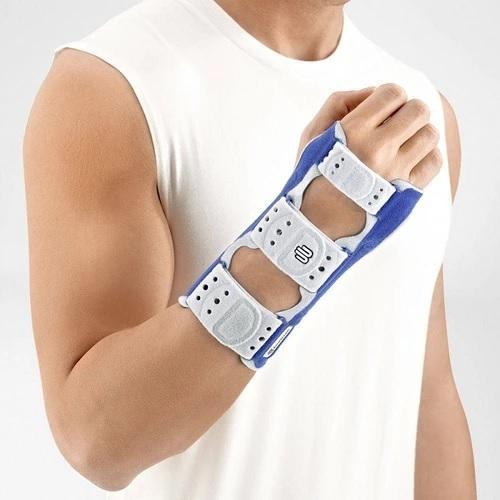 Wrist brace in a colour combination of blue and grey and is worn on the right wrist. It is considered one of Bauerfeind Australia's best recovery wrist braces, Manuloc Wrist Brace.