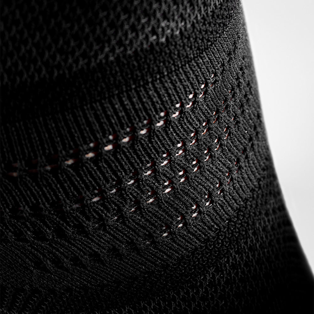 Closeup of the fabric on a black Bauerfeind Sports Knee Support NBA