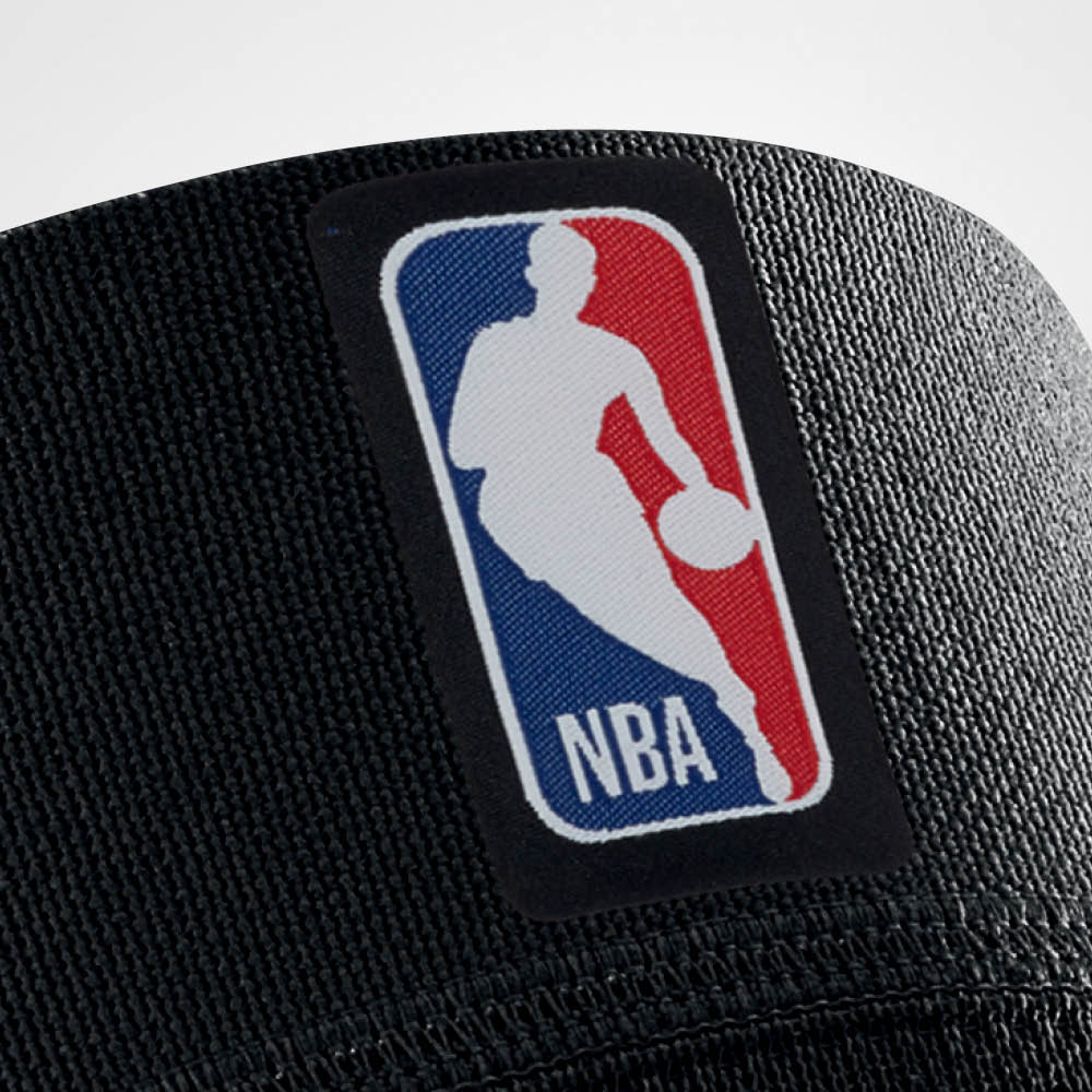 Closeup of the logo on a black bauerfeind Sports Compression Knee Support NBA